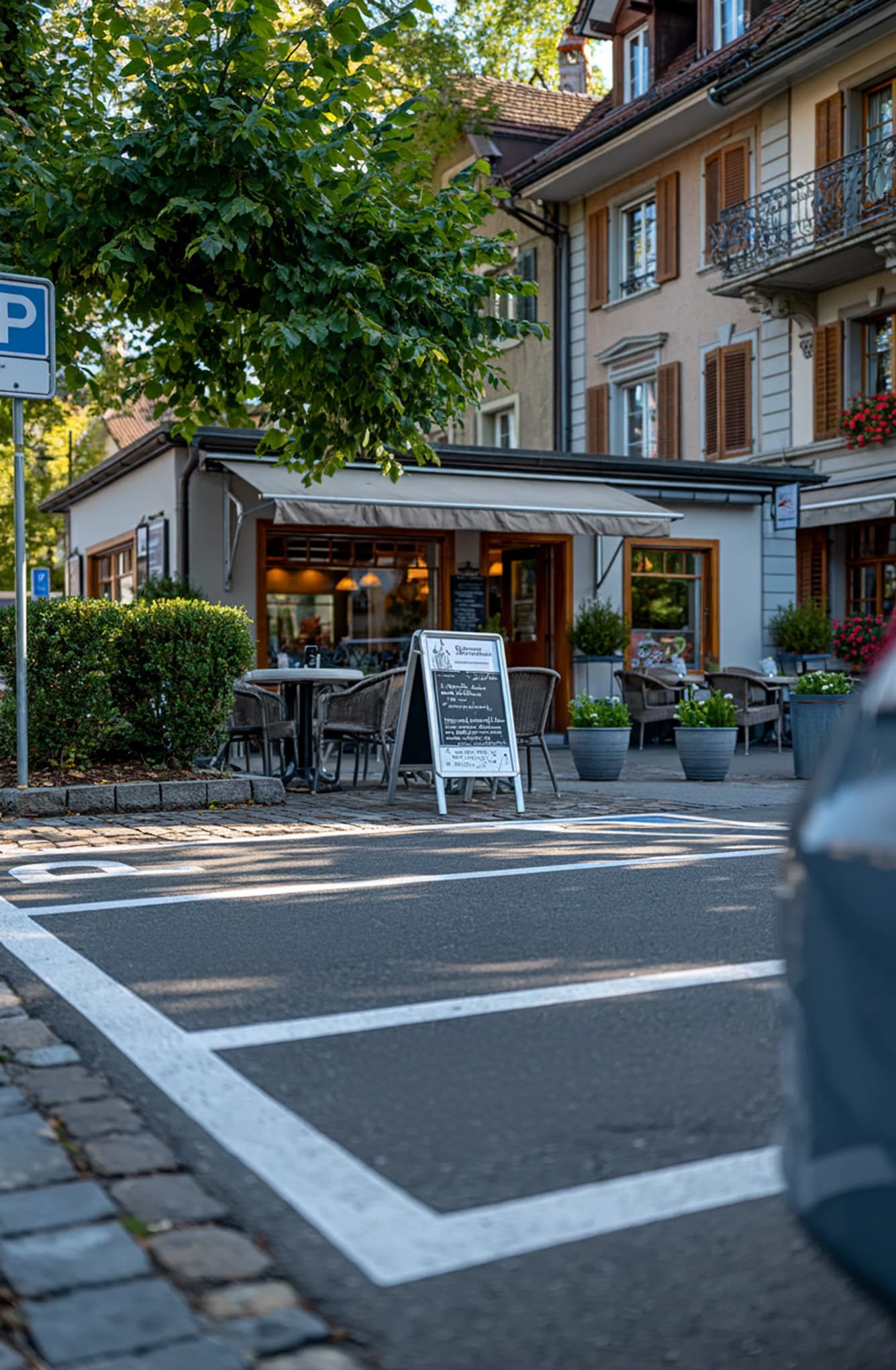 Parking spaces in front of a restaurant with outdoor seating