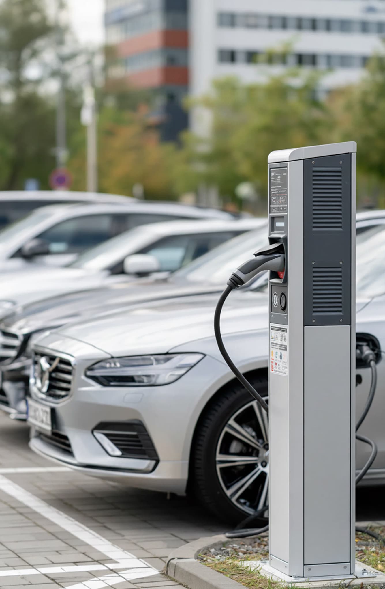 Electric car at a charging station on an urban street