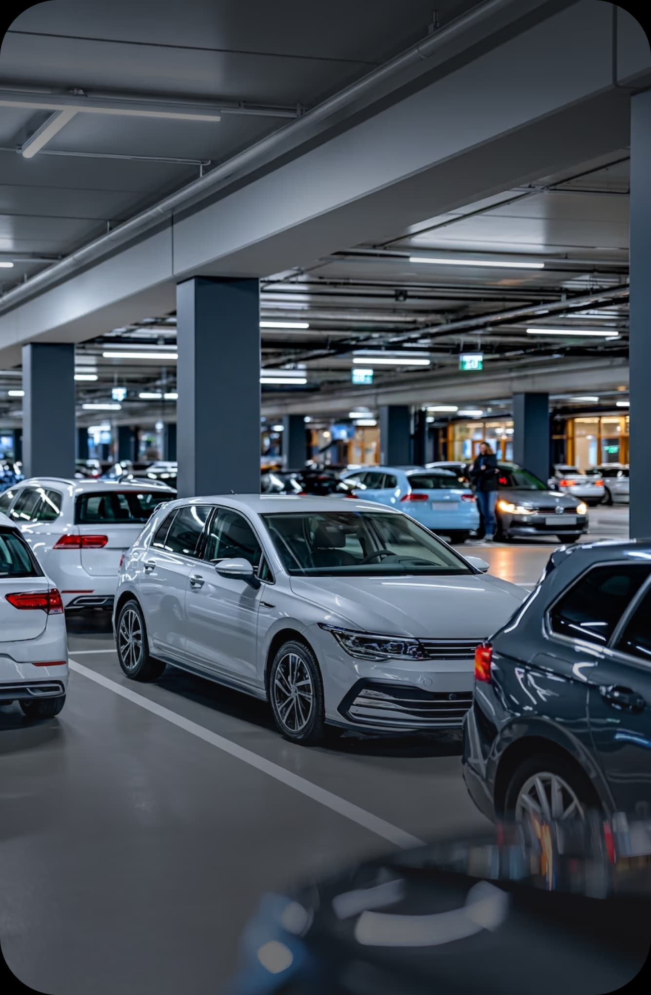 A level of a public multi-storey car park with parked vehicles